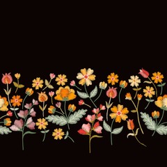 Vector embroidery border with cute wild flowers. Seamless floral embroidered pattern on black background. Fahion design for clothing.
