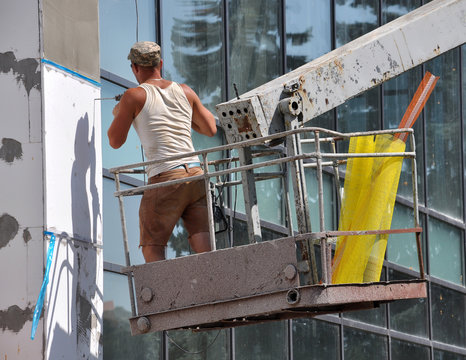 The worker insulation the facade of the building