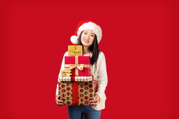 Beautiful smiling asian woman wearing knitted sweater celebrating Christmas. Portrait of attractive brunette casual female at new years eve. Background, copy space, close up.