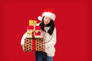 Beautiful smiling asian woman wearing knitted sweater celebrating Christmas. Portrait of attractive brunette casual female at new years eve. Background, copy space, close up.