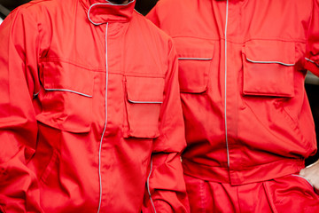 Close-up of a red working uniforms of auto mechanics