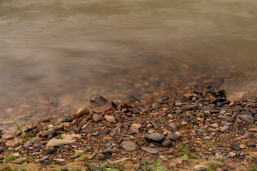 Waterfall flows through the rocks into small streams.