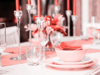 Beautiful table setting in Living Coral color. Living coral is color of the Year 2019. Shallow DOF