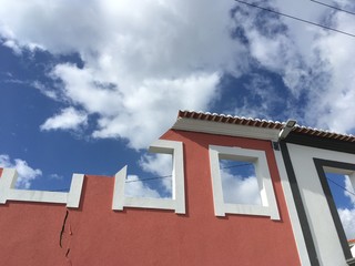 half cut building facade on blue sky