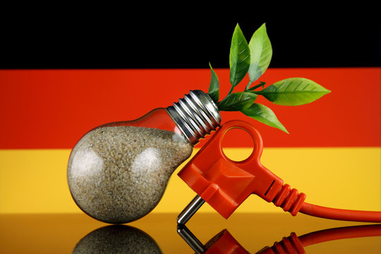 Plug, plant growing inside the light bulb and Germany Flag. Green eco renewable energy concept.
