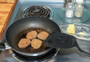 Skillet on Electric Stove Frying Sausage Patties