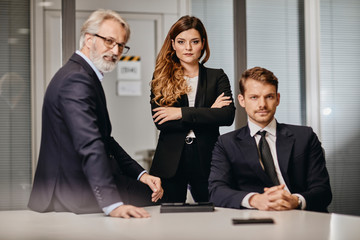 A couple of bussinessmen and bussines woman discussing an important topic