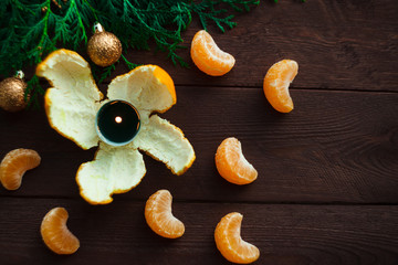 New Year and Christmas concept. fir branches, candles and mandarin. winter mood. selective focus