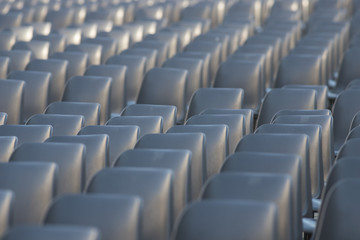 Rows of new grey chairs in the conference hall