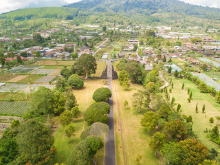 Obraz premium Aerial view of Ancient Bali gate with pathway in Bedugul village. North of Bali island, Indonesia