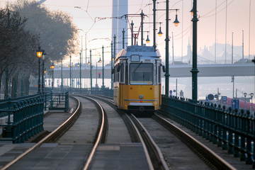 Fototapeta na wymiar Old fashioned tram on a riverfront tramway in Budapest city, early morning