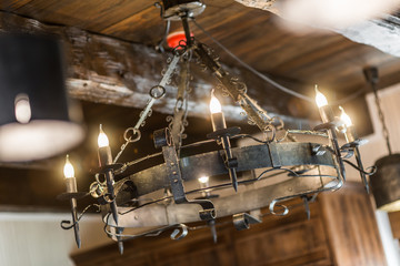 Fototapeta na wymiar Old vintage candelstick chandelier of wrought iron