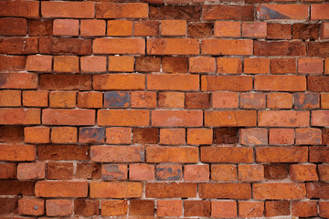 The texture of an old wheatered red brick wall, background