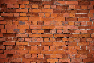 The texture of an old wheatered red brick wall, background