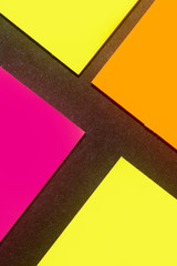 Yellow, orange and purple hue colorful office stickers on black paper. Office noteparer as...