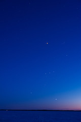 Orion constellation above frozen lake