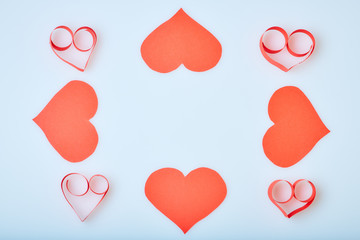 Valentine's Day theme with composition of red paper hearts for cards and backgrounds
