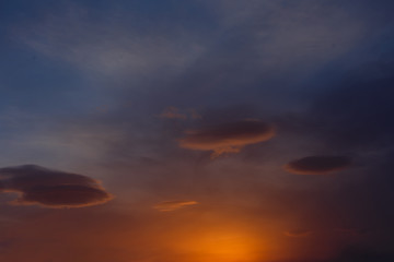 three clouds in the colorful sky