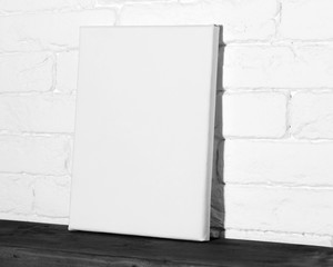 Blank canvas in modern interior. Poster template, side view.