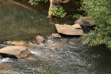 The waterfall flows through the rocks into small streams at Pong river Chanthaburi Thailand.