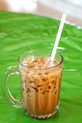 Side view of black tea with ice, one of the most famous tea in Malaysia, put on a street stall table.