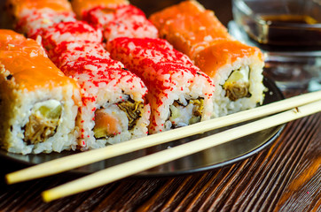 two types of sushi rolls with flying fish roe