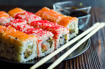 two types of sushi rolls with flying fish roe