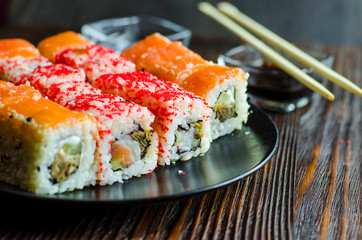 two types of sushi rolls with flying fish roe