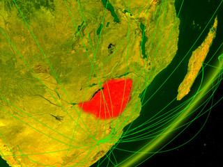 Zimbabwe on green model of planet Earth with network at night. Concept of digital technology, communication and travel.