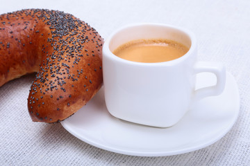 Classic espresso in white cup and croissant on white background. Top view.