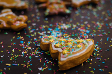 Christmas bakery. Friends decorating freshly baked gingerbread cookies with icing and confectionery mastic, view from above. Festive food, family culinary, Christmas and New Year traditions concept
