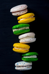 Macaroons on dark background, colorful french cookies macarons. 