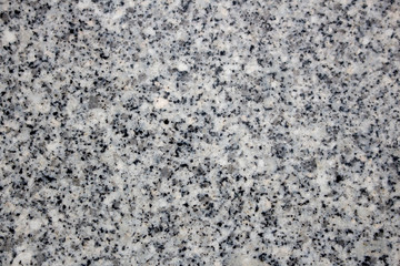 Natural granite stone surface. Black, gray and white colored granite texture.