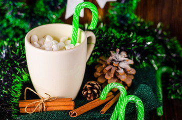 cup of drink with marshmallows on christmas background