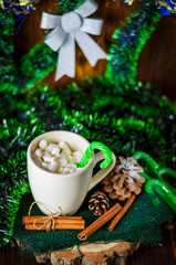 cup of drink with marshmallows on christmas background