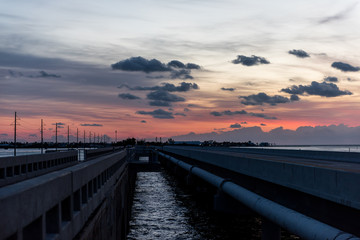 Fototapeta na wymiar Sunrise in Islamorada, Florida Keys, with red blue sky, overseas highway road, village of islands, in Atlantic Ocean, gulf of Mexico, horizon