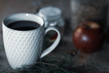 cup of coffee with beans on wooden background
