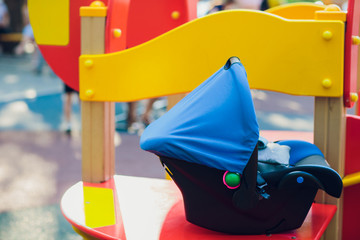 Empty blue baby stroller in a park - Missing child concept.