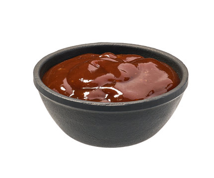 Barbecue sauce in  black bowl isolated on white background