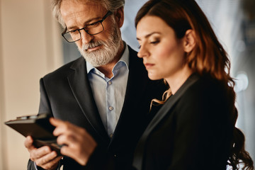 Co-workers discussing an important matter on a empty hallway. 