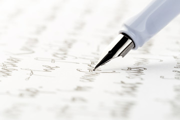 white fountain pen writing a letter