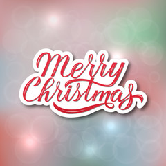 Merry Christmas hand lettering on blurred gradient background. Celebrations quote calligraphy with brush. Holidays mood vector illustration.