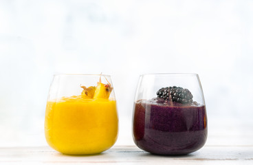 Colorful yellow and blue smoothie in two glasses