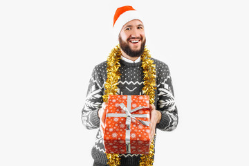 A man with a Christmas gift in his hands, in the Studio on a white background