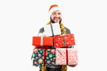 man holds a lot of Christmas gifts in the Studio on a white background, choose a gift