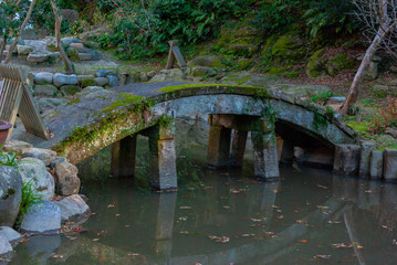 Fototapeta na wymiar stone bridge in japanese garden