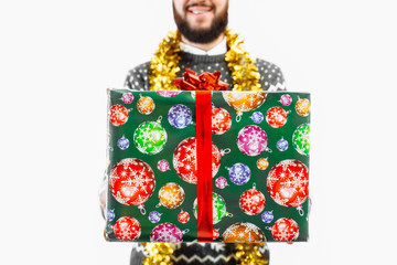 A man with a Christmas gift in his hands, in the Studio on a white background, gift close-up