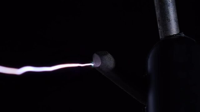 FIRING STUN GUN CONTACT IN MACRO ECU.  IN 4K, 10 BIT, 4:2:2.  HIGH VOLTAGE ELECTRICAL CHARGES ARCING ACROSS TWO CONTACTS.