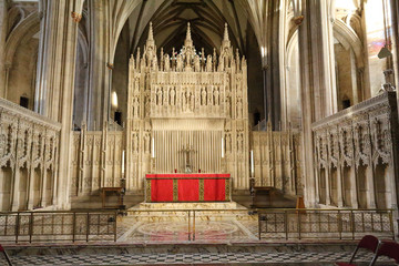 The main altar in the central nave of the Bristol Cathedral, with pointed arches and Gothic decorations in South West England, United Kingdom