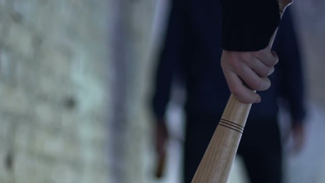 Teenage hand holding baseball bat, threat and juvenile delinquent, youth gang